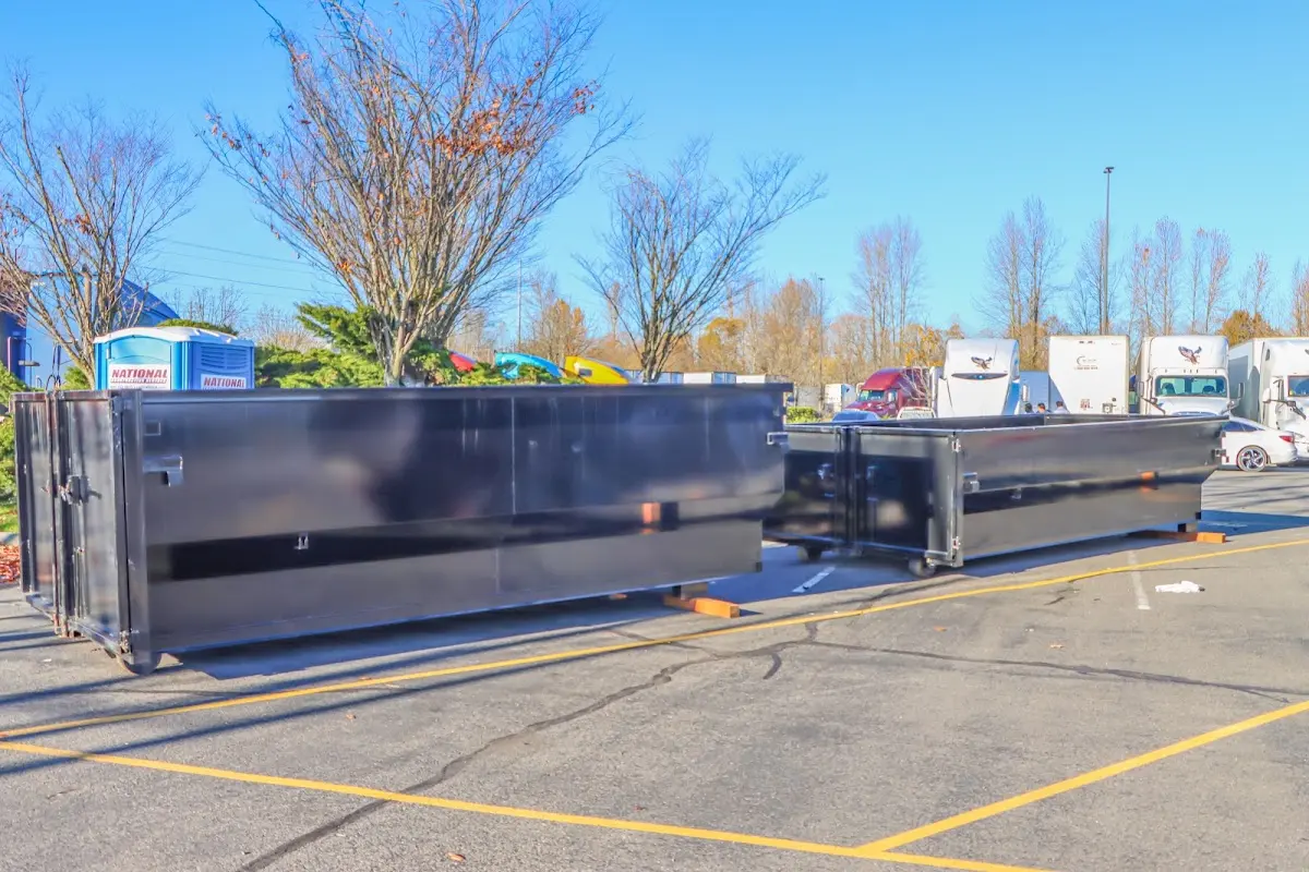 Professional dumpster rental service with roll-off container on residential driveway in Myrtletown